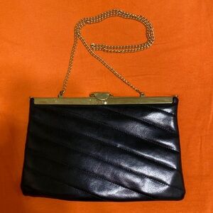 Cocktail bag with chain (31”) strap and clasp in the center used